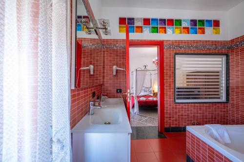 a bathroom with a white sink and red tiles at BBC Christian Bed & Breakfast in Pisa