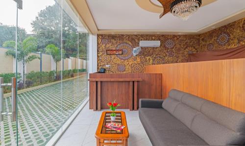 a living room with a couch and a table at Itsy By Treebo - Kurinji Stay Inn in Yelagiri