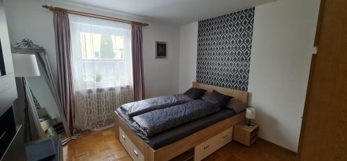 a bedroom with a futon in front of a window at Nomadengold in Ottobrunn