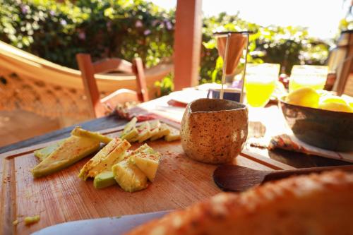 a wooden table with a cutting board with food on it at Casa Örüm in Florianópolis