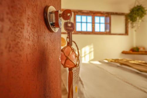 a wooden door with a key in a room at Casa Örüm in Florianópolis