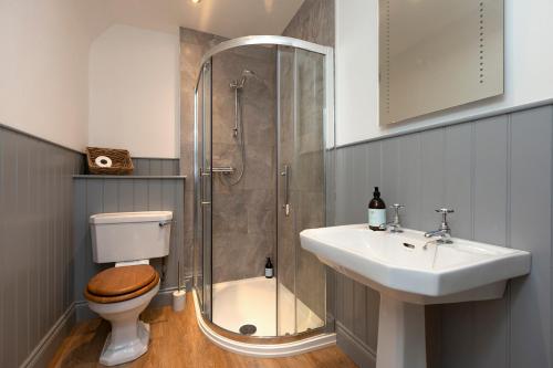 a bathroom with a shower and a toilet and a sink at Stableyard Studio: Drumlanrig Castle in Thornhill