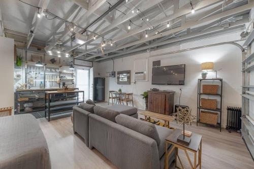 a living room with couches and a kitchen at Ultimate Man Cave Garage studio minutes to Whatever YOU do in Tampa