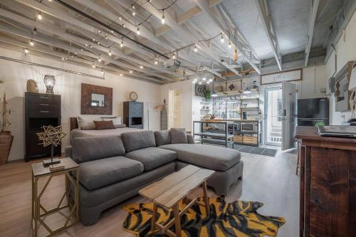 a living room with a couch and a table at Ultimate Man Cave Garage studio minutes to Whatever YOU do in Tampa
