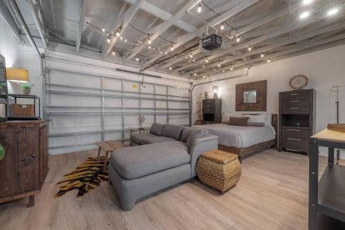 a bedroom with a bed and a couch and a bed and a bed at Ultimate Man Cave Garage studio minutes to Whatever YOU do in Tampa