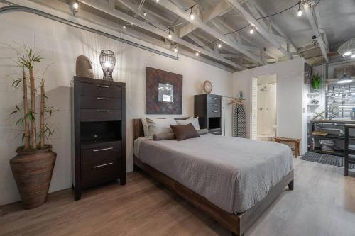 a bedroom with a bed and a television in it at Ultimate Man Cave Garage studio minutes to Whatever YOU do in Tampa