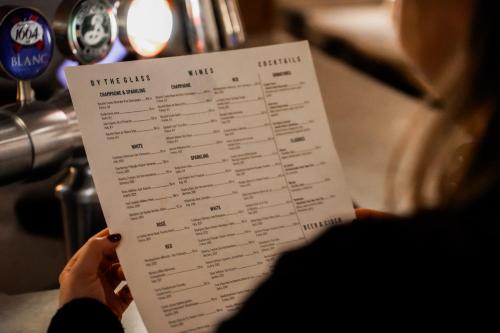 a person is holding a piece of paper with a menu at Clarion Hotel Grand Östersund in Östersund