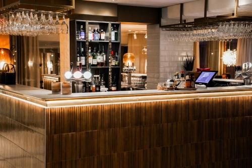 a bar in a restaurant with a laptop on the counter at Clarion Hotel Grand Östersund in Östersund