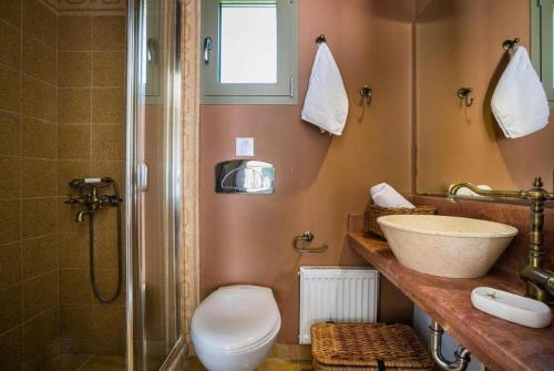 a bathroom with a sink and a toilet and a shower at Astounding Seafront Kefalonia Villa - 3 Bedrooms - Villa Alegria - Private Pool and Amazing Sea Views - Minies in Kefallonia