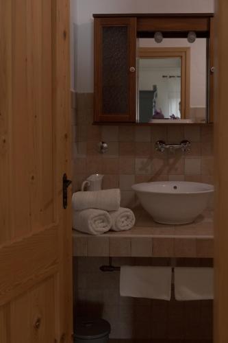 a bathroom with a sink and a mirror and towels at Holiday home Sika in Miškovići