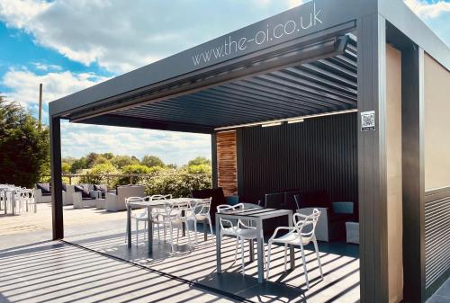 a restaurant with white chairs and tables on a deck at The Punchbowl Lapworth in Solihull