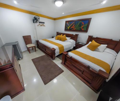 Postel nebo postele na pokoji v ubytování Hotel Aires del Quindío Armenia
