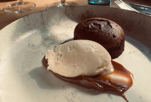 a chocolate muffin and ice cream on a plate at The Punchbowl Lapworth in Solihull
