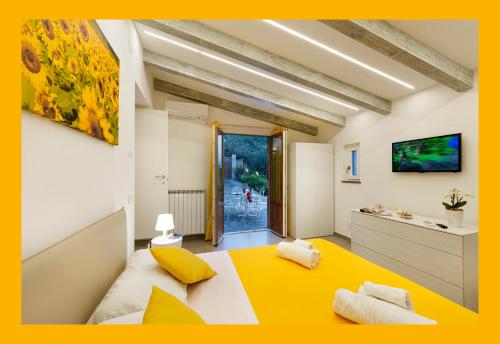 a bedroom with a yellow and white bed in a room at Holidays Homes The dream in Sant'Agnello