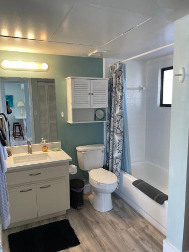 a bathroom with a toilet and a sink and a tub at Ocean Village Club in Saint Augustine