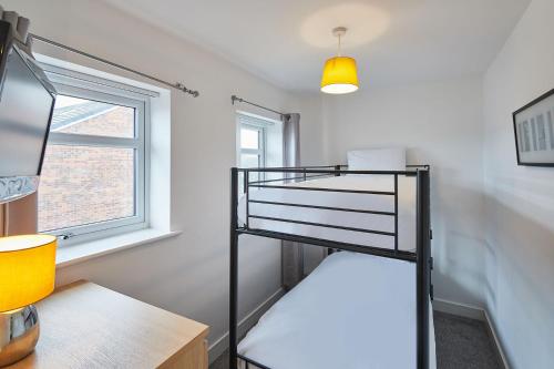 a bunk bed in a room with a window at Jackson Court Apartment 3 in Marske-by-the-Sea
