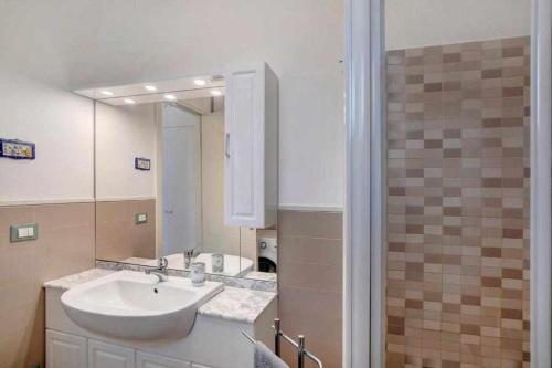 a bathroom with a sink and a mirror at Ninfea apartments in Sanremo