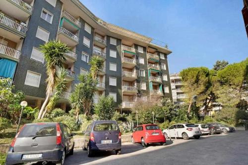 a parking lot with cars parked in front of a building at Ninfea apartments in Sanremo
