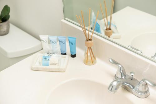 a bathroom counter with a sink and a mirror at Golden Bay 808 in Miami Beach
