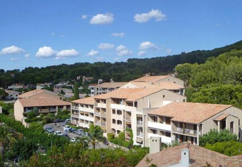 a group of apartment buildings with a parking lot at Studio Saint Cyr sur mer,Vue mer in Saint-Cyr-sur-Mer