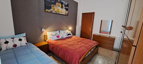 a small bedroom with a bed and a mirror at Family Dreams in Turin