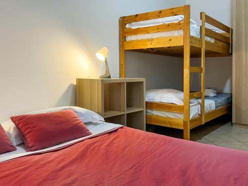 a bedroom with two bunk beds and a red bed at Gianicolo - Spacious flat for family and friends in Rome