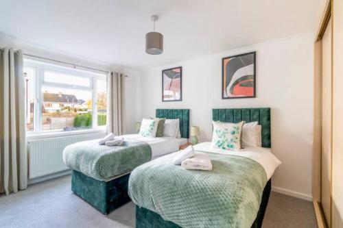a bedroom with two beds and a window at Large Sea View 2 bedroom Sleeps 6 - Free Parking in Bournemouth