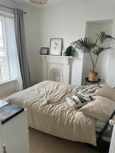 a bedroom with a bed and a fire place at Home in West by the Sea in Llanelli