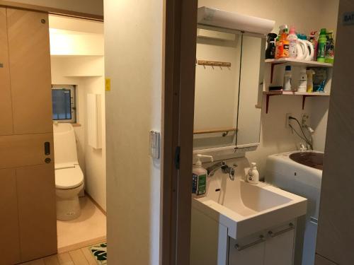 a small bathroom with a sink and a toilet at Sunny moe oo in Tokyo