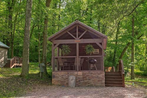 a gazebo in the middle of a forest at Lena Cabin Wooded Tiny Cabin - Hot Tub in Chattanooga