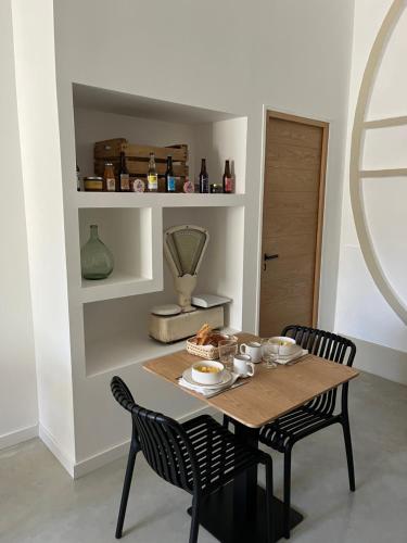 a dining room table with two chairs and a table and a table at Le Chai in Nissan-lez-Enserune
