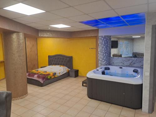 a room with a bath tub and a bed in it at Jacuzzi Apartament Old town in Klaipėda