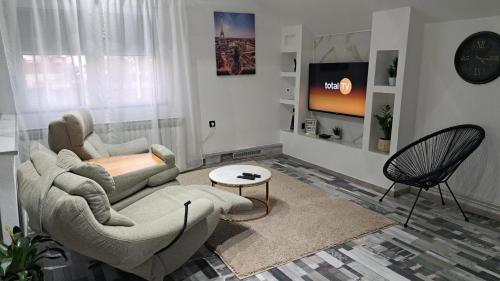 a living room with a couch and a chair at Apartman Mihaela in Laktaši