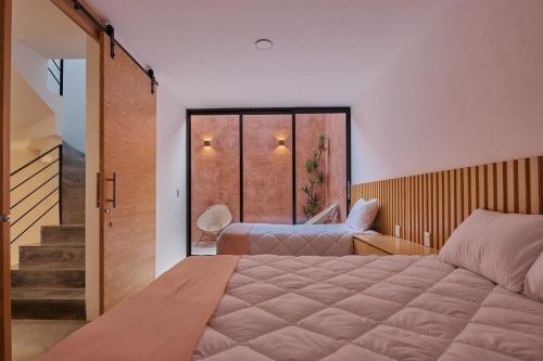 a bedroom with a large bed and a large window at Hermosa casa ubicada en Oaxaca in Oaxaca City