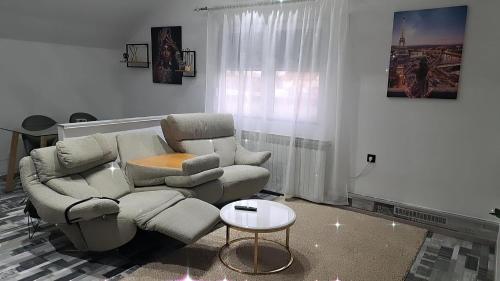 a living room with a couch and a table at Apartman Mihaela in Laktaši