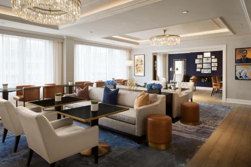 a living room with a couch and tables and chairs at The Fairmont Washington DC in Washington, D.C.