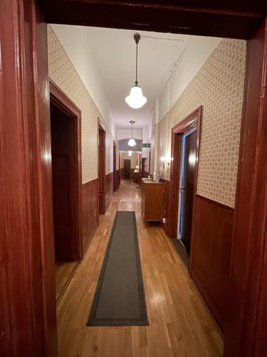 a hallway with a rug in the middle of a building at Lilla Hotellet in Sundsvall