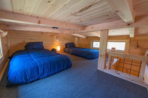 a bedroom with two beds in a log cabin at Jake Cabin Luxury Hot Tub Cabin Near Downtown in Chattanooga