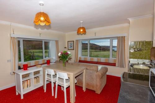 a living room with a table and a couch at Ormsaig Byre in Beach