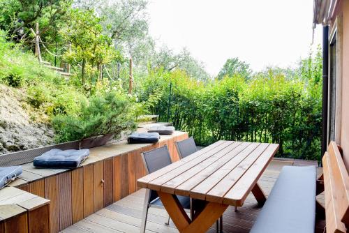 a wooden deck with a wooden table and chairs at Rock Garden Apartment in Arco