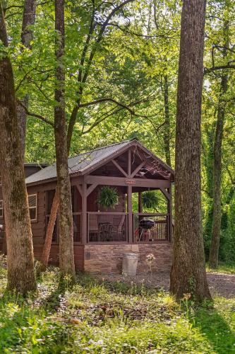 a log cabin in the woods with trees at Lena Cabin Wooded Tiny Cabin - Hot Tub in Chattanooga