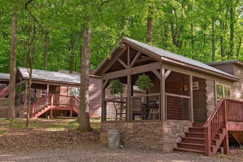 a cabin in the woods with a porch and stairs at Lena Cabin Wooded Tiny Cabin - Hot Tub in Chattanooga