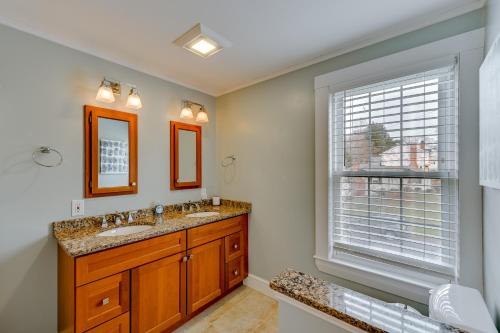 a bathroom with two sinks and a window at Home with Backyard about 2 Mi to Downtown Lexington! in Lexington