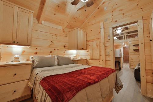 a bedroom with a bed in a wooden cabin at Martha Cabin Tiny Cabin By Downtown Chattanooga in Chattanooga