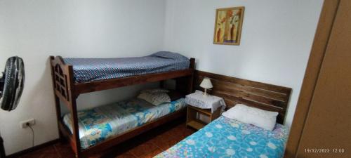 a small bedroom with two bunk beds in it at Alojamiento Cuchi Corral in San Luis