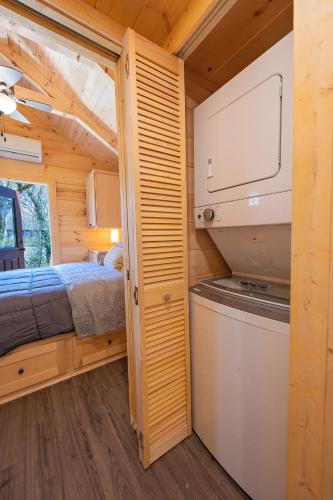 a bedroom and a bed in a tiny house at Nana Cabin Tiny Log Home Comfort In Rustic Bliss in Chattanooga