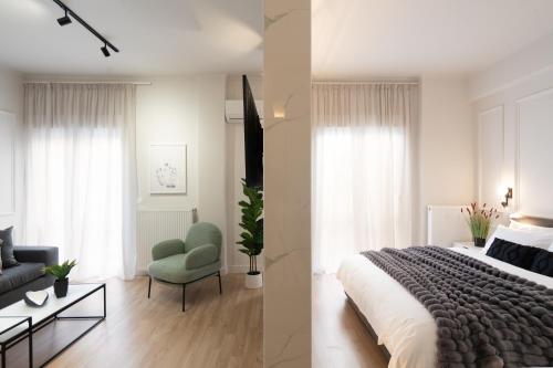 een slaapkamer met een bed, een bank en een stoel bij Artsy Loft in the heart of Koukaki in Athene
