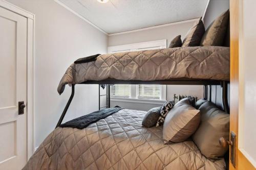 a bedroom with two bunk beds in a room at Walk to Lake Harriet 1 Block to Restaurants in Minneapolis