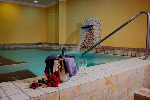 a swimming pool with a bucket and a water fountain at Hotel Corona & Spa in Pescasseroli