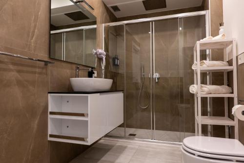 a bathroom with a shower and a sink and a toilet at La casa sul Naviglio in Milan